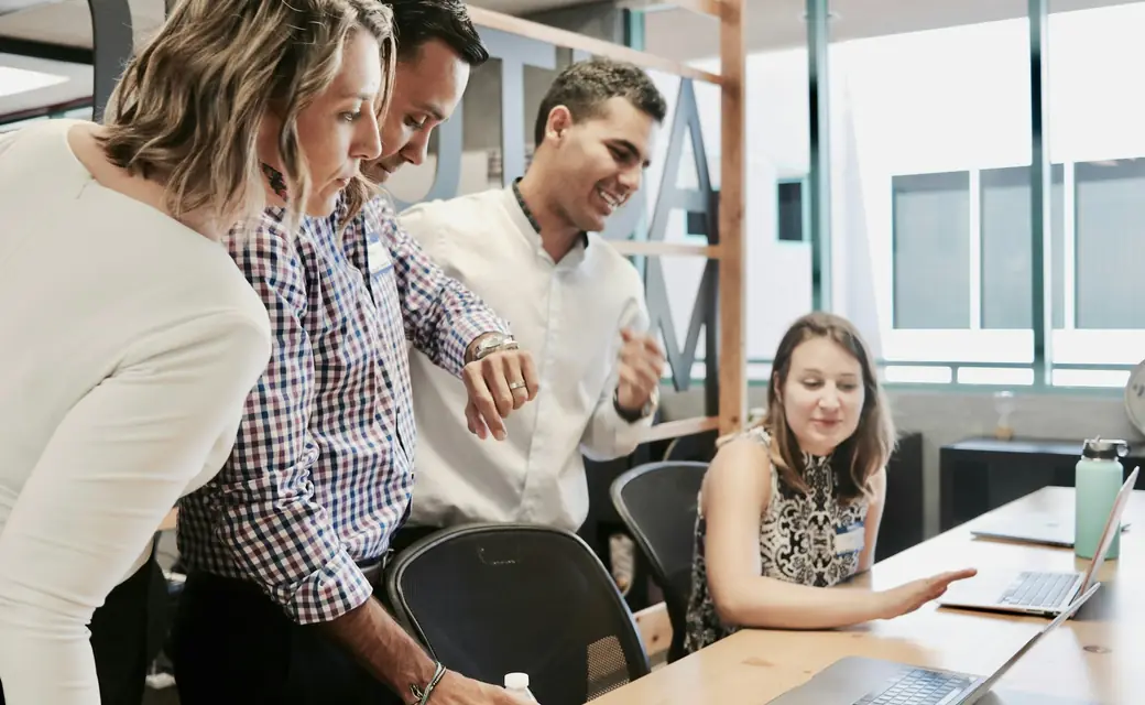 A team reviewing work together in a bright office